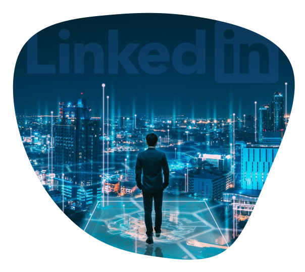 A man standing in the building facing the LinkedIn logo